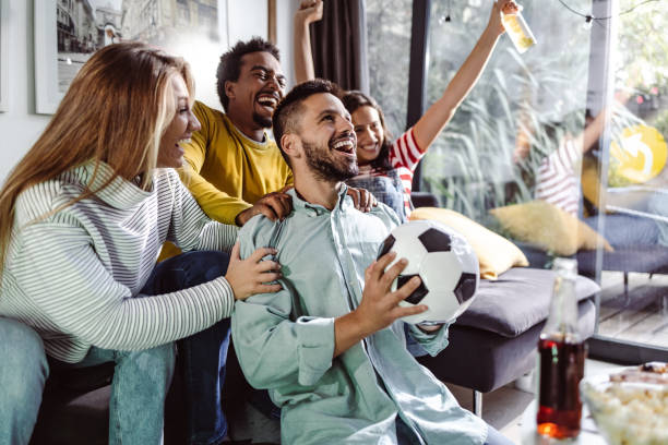 istock Excited fans shouting while watching match on TV 1432346017