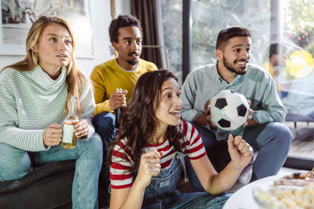 istock Friends at home watching sports match 1432346187