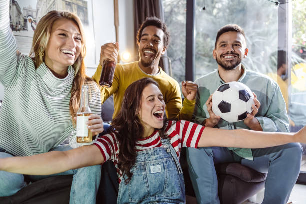 istock Excited fans shouting while watching match on TV 1432346217