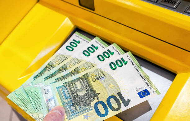 istock Depositing and withdrawing cash euro banknotes from an ATM 1432347270