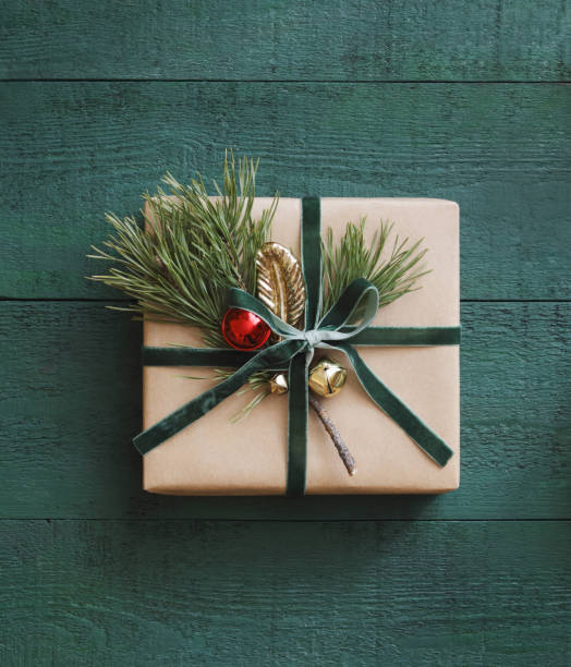 Christmas present, green wood background High angle view of Christmas present wrapped in kraft paper red green and gold christmas trees stock pictures, royalty-free photos & images