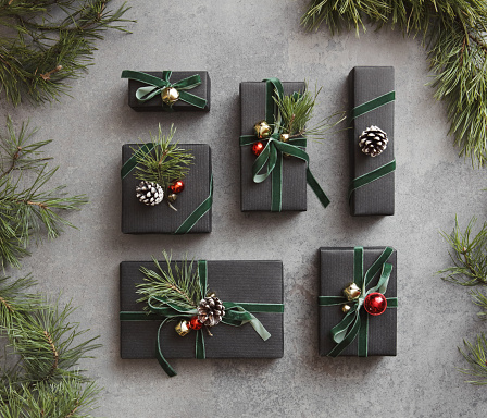 High angle view of Christmas presents wrapped in black paper and ornaments
