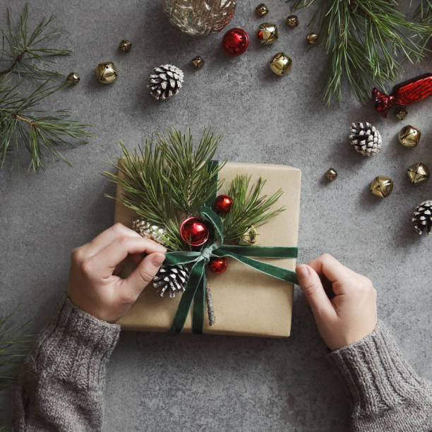 istock Woman decorating Christmas present 1432349734