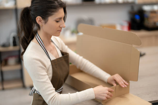istock Florist working with flowers making a composition ghift box 1432350578