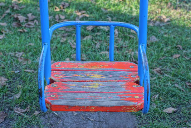 istock one empty swing seat made of blue metal and red boards 1432352564