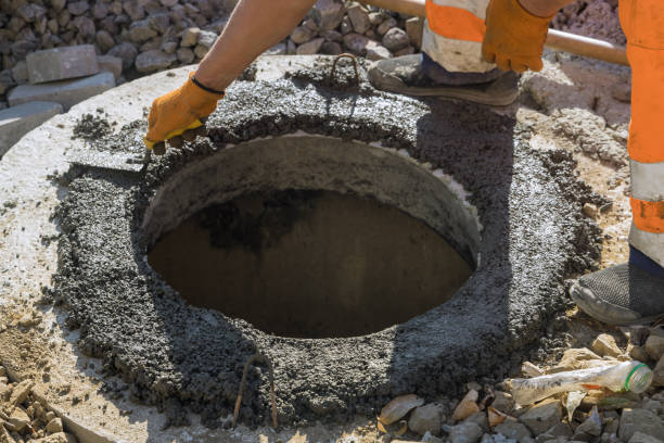 istock There is a utility worker who is constructing a pit for a septic tank the sewerage manhole, and reconstructing the sewage system 1432353165