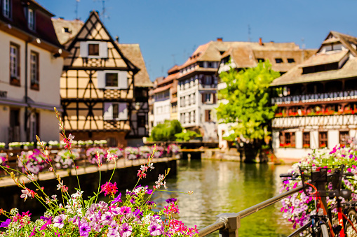 Alsace. Old ancient French city Strasbourg. Summer trip to France. European country. French architecture. Voyage. Warm sunny day. Travel destination. Street. Facade of houses. Il river