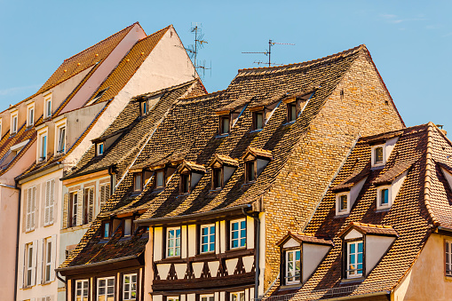 Roof of house. Alsace. Old ancient French city Strasbourg. France. European country. French architecture. Warm sunny day. Travel destination. Street. Facade of houses