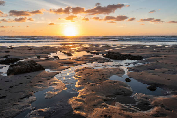 istock Stunning Summer sunset landscape image of Widemouth Bay in Devon England with golden hour light on beach 1432353375