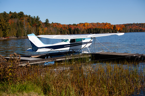 Single engine plane on lake on a fall day.