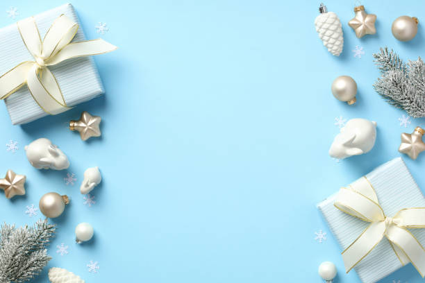 istock Christmas flat lay composition with present boxes and beige decorations on pastel blue background. 1432356405