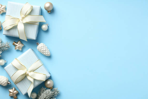 istock Winter holidays composition with gift boxes, baubles, stars, pine cones on pastel blue background. Christmas greeting card template. Happy New Year cover design. 1432356415