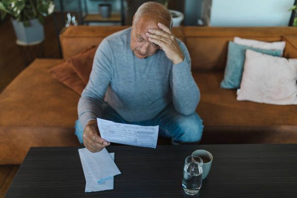 istock Senior Man Looking at an Expensive Utility Bill 1432357569