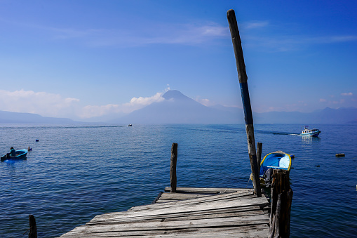 Beautiful view of the Atitlan lake an the Volcanos in the Guatemala  - with small towns and tourist boats
