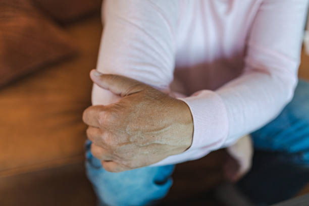 istock Man Holding Elbow in Pain 1432359160