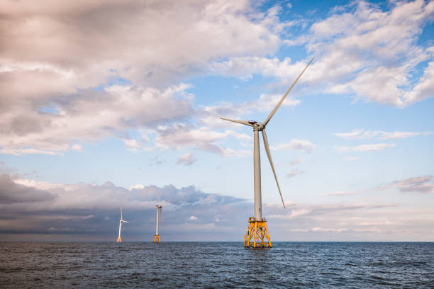 istock three wind turbines off shore with clouds in middle of ocean 1432360884