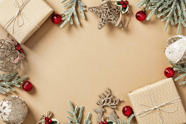 istock Vintage Christmas background with gift boxes, fir branches, elegant decorations on beige table. Flat lay, top view, copy space. Christmas frame, banner design, New Year postcard template. 1432361299