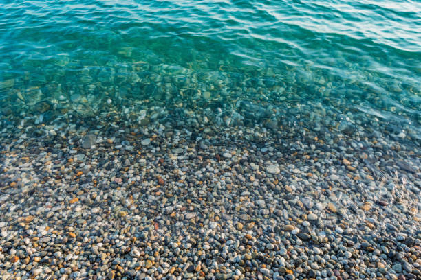 istock Small stones with sea wave on the beach. 1432362055