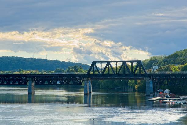 istock Railroad bridge over Merrimack river under cloudscape in Haverhill Massachusetts. 1432363203