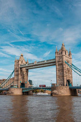 Tower Bridge in London spans the River Thames and is listed as a bascule and suspension bridge.