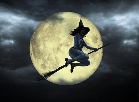 Funny witch flying on broom over moon (Photo of the moon: NASA).