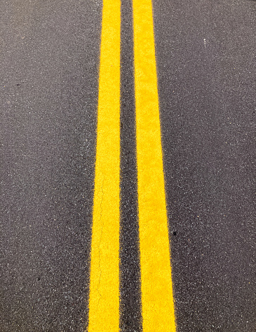 Double Yellow Line on Asphalt Road Close-Up