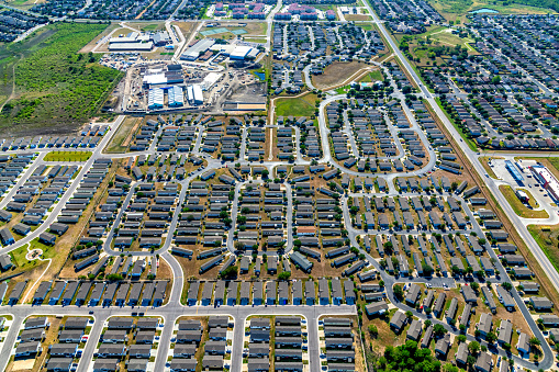A large master planned, suburban residential community located near downtown Austin, Texas shot from an altitude of about 1200 feet on a clear sunny morning.