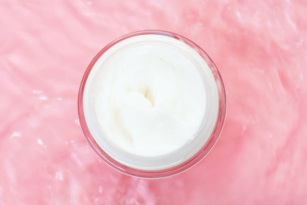 istock Jar cream underwater on pink background close-up top view. 1432372990