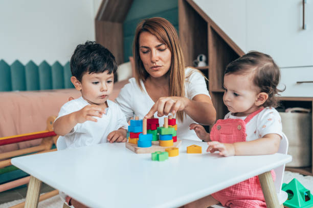 istock Mother playing with toddlers 1432373626