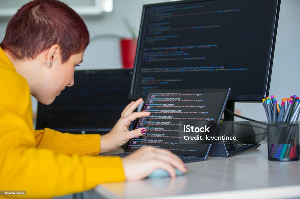 Female Programmer Coding On A Desktop Computer And Laptop Stock Photo ...
