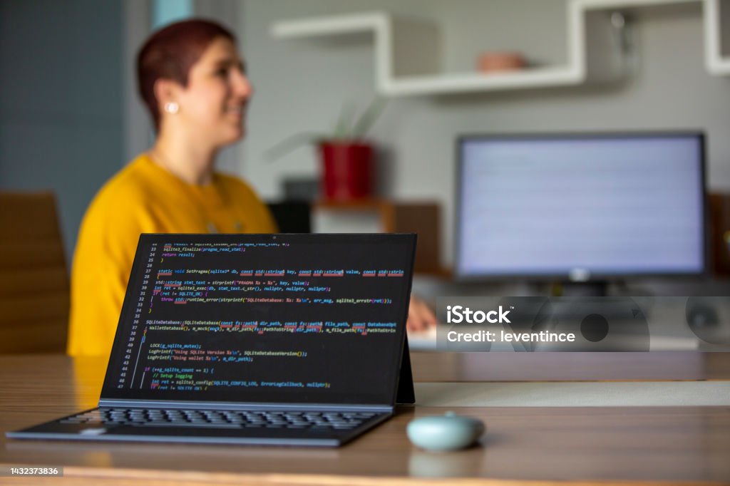 Female Programmer Coding On A Desktop Computer And Laptop Stock Photo ...