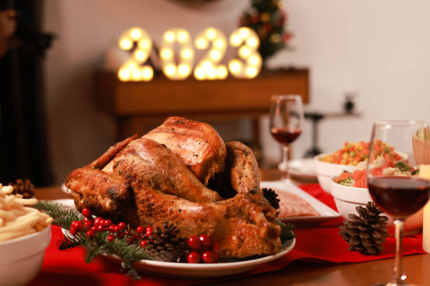 Huge delicious bake chicken serve on dining table to celebrate Christmas 's eve or new year Huge delicious bake chicken serve on dining table to celebrate Christmas 's eve or new year CHICKEN MEAT stock pictures, royalty-free photos & images