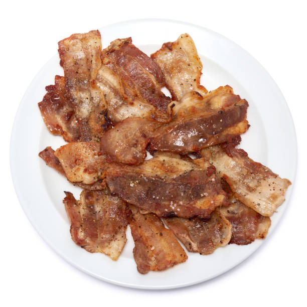 istock Cooked slices of bacon on white ceramic plate isolated on white background 1432377884