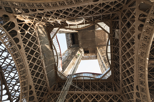 Inside the Eiffel tower. Close up of the iron structure. Distinctive symbol and famous tourist attraction of Paris, France, selective focus