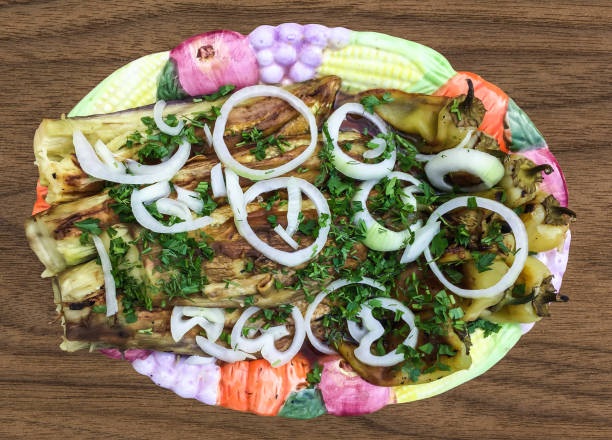 istock Fried eggplants with greens and onions on a plate. view from above 1432383861