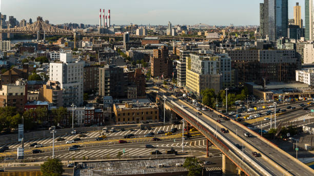 Busy traffic on Pulaski bridge in Long Island City. Panoramic view of Astoria, Roosevelt Island and Upper East Side Manhattan over the Queensboro Bridge. stock photo