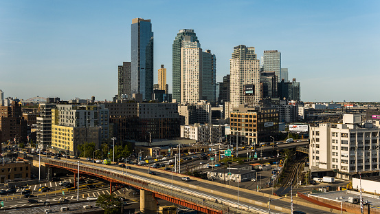 Pulaski Bridge with the traffic on it and modern towers of Long Island City view in the morning.