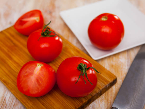 istock Fresh organic tomatoes on wooden kitchen table 1432386504