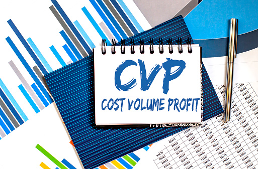 Notebook with text CVP Cost Volume Profit on chart background