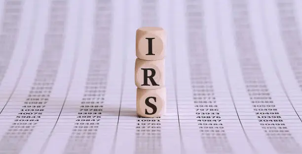 Photo of IRS word on a wooden cubes on the chart background