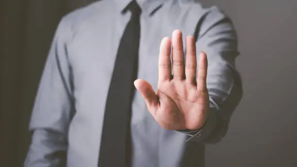 Photo of man hand stop sign, warning concept, refusal, caution, symbolic communication, preventing subsequent problems