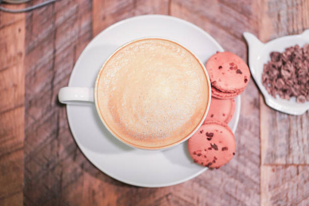 Latte in a mug and Macaroons on a table
