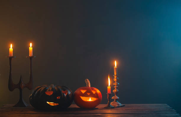 istock halloween pumpkins with burning candles on dark background 1432396307