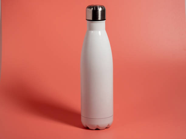istock White Thermal bottle on a pink background. Thermos bottle 1432398220