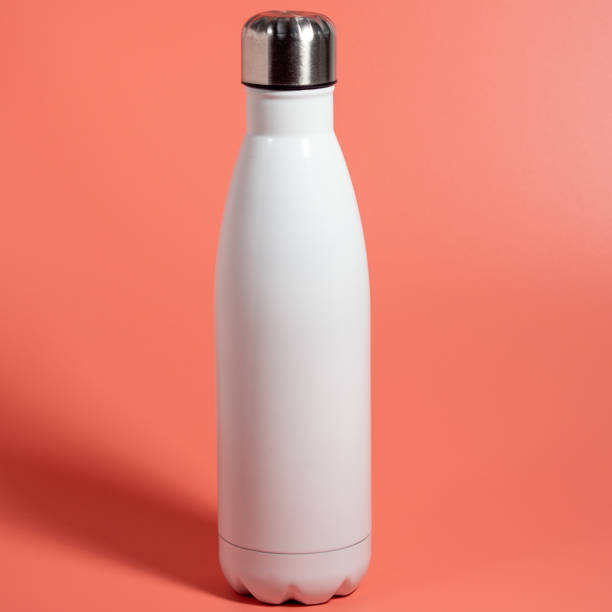 istock White Thermal bottle on a pink background. Thermos bottle 1432398224