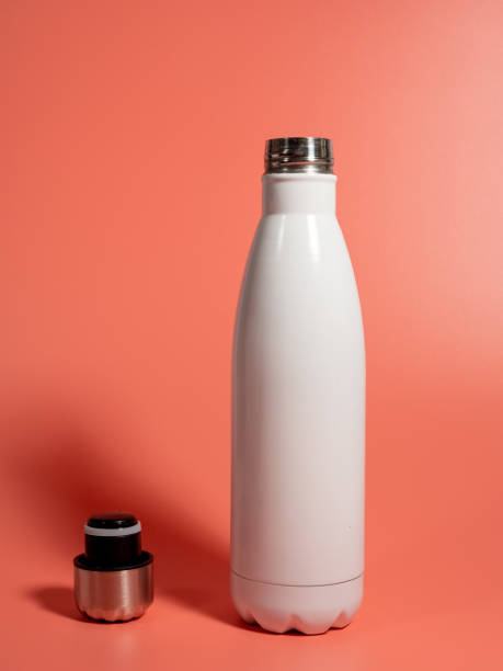 istock White Thermal bottle on a pink background. Thermos bottle 1432398228
