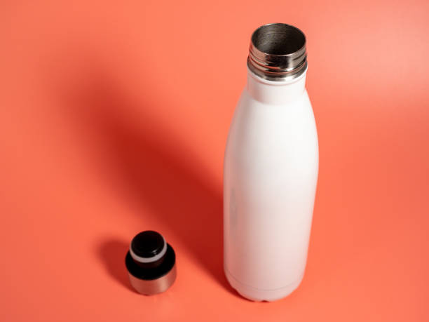 istock White Thermal bottle on a pink background. Thermos bottle 1432398230
