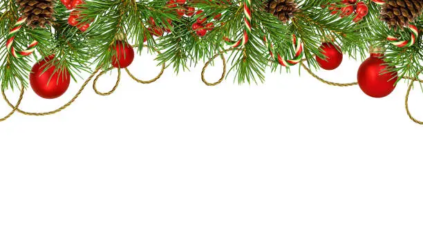 Photo of Christmas decorative top border with pine tree, red balls and berries, cones, candies and golden rope isolated on white