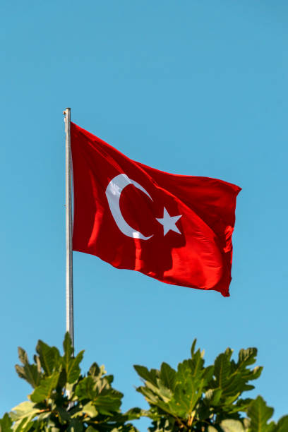istock Turkish flag on a background of blue sunny sky. 1432399385