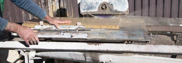 istock Electric tile cutter. Tiler cutting tile on wet saw machine 1432399709
